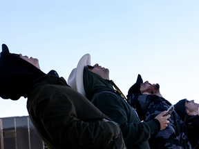 Onlookers watch as Blue Origin’s New Shepard flies toward space. The December 2021 flight was the third human space flight for the company which is owned by Amazon founder Jeff Bezos.