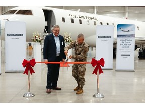 Steve Patrick, VP of Bombardier Defense welcomes Lt Col Eric Inkenbrandt, USAF BACN Material Leader to cut the ribbon and celebrate their new Global 6000 BACN aircraft.