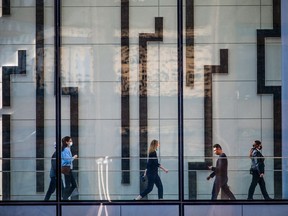 Office workers walk through Brookfield Place in downtown Calgary on Thursday, March 10, 2022.