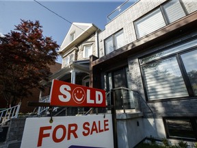 A sold sign sits in front of a house in Toronto on Tuesday July 12, 2022. The Toronto Regional Real Estate Board says August sales were down 34 per cent since last year, but up almost 15 per cent from July, as buyers returned to the market to take advantage of prices that eased from winter's elevated levels.
