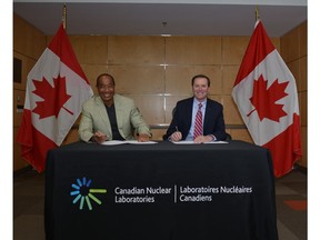 Left to right, Michael Lee-Chin, Chairman of Portland Holdings Limited, and Joe McBrearty, President and CEO of Canadian Nuclear Laboratories, sign a Memorandum of Understanding to collaborate on the pursuit of long-term solutions in fields that include clean energy, health sciences and environmental responsibility.