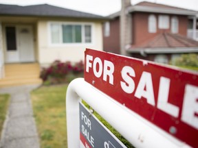 A real estate sign is pictured in Vancouver. Home sales in the city may have plummeted 40 per cent in August from a year ago but the composite benchmark price reached more than $1.1 million, a seven per cent increase over August 2021.