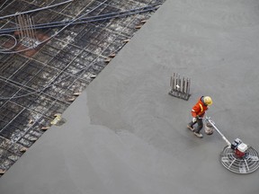 A worker smooths concrete at a construction site in Toronto on January 16, 2020.