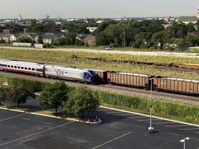 An Amtrak passenger train and a freight train head northbound towards downtown Chicago Wednesday, Sept. 14, 2022, in Chicago. Business and government officials are preparing for a potential nationwide rail strike at the end of this week while talks carry on between the largest U.S. freight railroads and their unions.