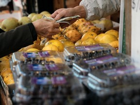 People shop at an outdoor food market in Manhattan, in New York City.