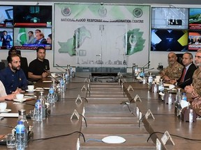 In this photo released by Pakistan's National Flood Response Coordination Centre, Hollywood actress and U.N. humanitarian Angelina Jolie, second left, attends a meeting with Pakistan's government and military officials about the damage caused by floods, in Islamabad, Pakistan, Wednesday, Sept. 21, 2022. Jolie was given a briefing by Pakistan's government and military officials on the flood damage. According to a statement released by the NFRCC, a military-backed emergency response center, Jolie said she will inform the world about the scale of devastation caused by the floods and climate change. (National Flood Response Coordination Centre via AP)