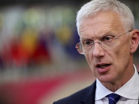 FILE - Latvian Prime Minister Krisjanis Karins speaks to the media as he arrives for an EU summit in Brussels, June 23, 2022. Latvians will vote on Saturday, Oct. 1, in parliamentary elections that have been significantly affected by neighboring Russia's invasion of Ukraine, political disunity among the Baltic country's large ethnic Russian minority, and economic problems , including high energy costs.  Opinion polls show that Karins' New Unity, which leads the current four-party center-right minority coalition, is likely to win the most votes, according to a forecast of 1.5 million eligible voters, with between 13 and 20 percent of the vote.  .  .