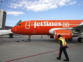 A Canada Jetlines Airbus A320 jet pulls up to the Calgary airport gate on the airline's inaugural flight Thursday.