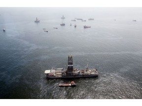 Oil sheen is seen with vessels assisting near the source of the BP Deepwater Horizon oil spill.