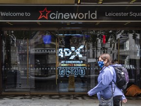 People walk past the Cineworld cinema in Leicester Square in London, England.
