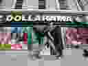 A pedestrian walks past a Dollarama Inc. store in Ottawa.