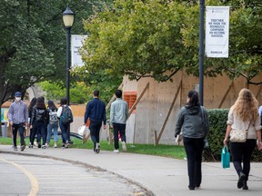 Students walk on the grounds of the University of Toronto campus in Toronto.