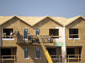 Crews install windows on a multi-unit housing build on Regina's east side.