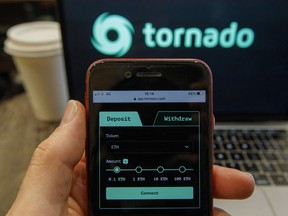 The Tornado Cash website displayed on a laptop and smartphone screen.
