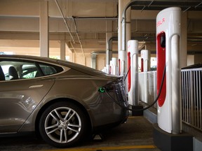 A Tesla Inc. electric vehicle charges at a supercharger station in Redondo Beach, California.