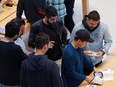 Customers shop at the Apple Inc. Fifth Avenue store in Manhattan, New York City.