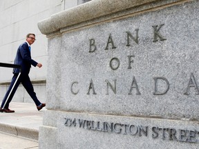 Bank of Canada Governor Tiff Macklem walking in front of the Bank of Canada building in Ottawa.