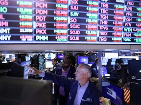 Traders work on the trading floor at the New York Stock Exchange.