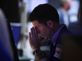 A trader works on the floor of the New York Stock Exchange.