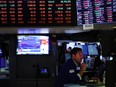 Traders work on the floor of the New York Stock Exchange in New York City.