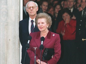 British Prime Minister Margaret Thatcher flanked by her husband Denis on Nov. 28, 1990 in front of 10 Downing Street in London.