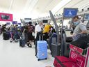 People wait in line to check in at Pearson International Airport in Toronto on Thursday, May 12, 2022.Toronto Pearson International Airport ranked among the lowest in customer satisfaction of all mega North American airports for the second year running according to a new J.D. Power airport satisfaction survey.