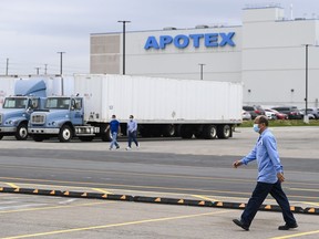 Apotex workers walk outside the company plant in Toronto on Friday, April 9, 2021. Apotex Pharmaceutical Holdings Inc. has signed a deal to be acquired by U.S. private equity investment firm SK Capital Partners.