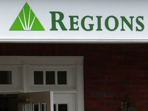 FILE - The logo for Regions Bank is seen above a branch's entrance in Roswell, Ga., Thursday, May 7, 2009. For a second time this decade, Regions Bank was found charging illegal overdraft fees, the government said Wednesday, Sept. 28, 2022, in a settlement that will require the bank to repay $141 million to customers and pay an additional $50 million in fees.