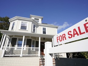 FILE - A for sale sign stands in front of a house on Oct. 6, 2020, in Westwood, Mass. Sales of previously occupied U.S. homes slowed in August 2022 for the seventh month in a row, as sharply higher mortgage rates and rising home prices made homebuying less affordable.