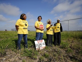 FILE - Myrtle Felton, from left, Sharon Lavigne, Gail LeBoeuf and Rita Cooper, members of RISE St. James, conduct a live stream video on property owned by Formosa on March 11, 2020, in St. James Parish, La. A Louisiana judge has thrown out air quality permits for a Taiwanese company's planned $9.4 billion plastics complex between New Orleans and Baton Rouge, Wednesday, Sept. 14, 2022, a rare win for environmentalists in a heavily industrialized stretch of the Mississippi River often referred to as "Cancer Alley."