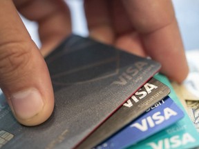 FILE - Visa credit cards are seen on Aug. 11, 2019, in New Orleans. Payment processor Visa Inc. said late Saturday, Sept. 10, 2022, that it plans to start separately categorizing sales at gun shops.