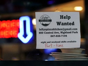 FILE - Hiring sign is displayed at a restaurant in Highland Park, Ill., Thursday, July 14, 2022. Fewer Americans filed for unemployment benefits last week as the labor market continues to shine despite weakening elements of the U.S. economy. Applications for jobless aid for the week ending Aug. 27, fell by 5,000 to 232,000, the Labor Department reported Thursday, Sept. 1.