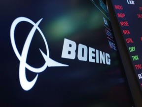 FILE - The logo for Boeing appears on a screen above a trading post on the floor of the New York Stock Exchange, Tuesday, July 13, 2021. Boeing is behind schedule in submitting documentation for new versions of its 737 Max jetliner, and it's asking Congress for more time. Federal officials say Boeing has completed little of the work necessary to certify the new Max versions by a Dec. 31, 2022 deadline.
