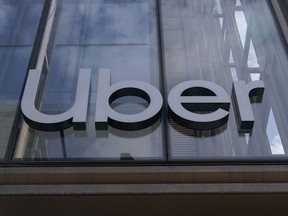 FILE - An Uber sign is displayed at the company's headquarters in San Francisco, Monday, Sept. 12, 2022. Uber said Thursday, Sept. 15, that it reached out to law enforcement after a hacker apparently breached its network. A security engineer said the intruder provided evidence of obtaining access to crucial systems at the ride-hailing service.