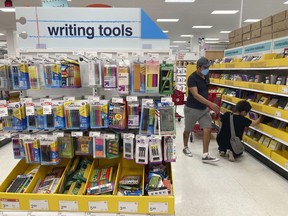 FILE - Shoppers look for school supplies at a store, Wednesday, July 27, 2022, in South Miami, Fla. Economists are saying strong consumer demand, spurred by rising wages, is fueling inflation.