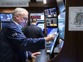 In this photo provided by the New York Stock Exchange, traders work on the floor of the exchange on Tuesday, Sept. 13, 2022.