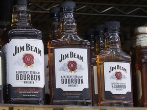 FILE - Jim Beam bottles are displayed at Rossi's Deli in San Francisco, July 9, 2018. Jim Beam plans to ramp up bourbon production at its largest Kentucky distillery to meet growing global demand in a more than $400 million expansion to be powered by renewable energy. The project will increase capacity by 50% at the Beam plant in Boston, Ky., while reducing greenhouse gas emissions by the same percentage, Beam Suntory said Wednesday, Sept. 14, 2022.