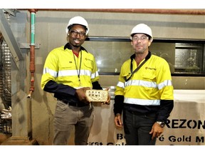 Orezone's Burkina Faso Country Manager, Ousseni Derra and VP, Project Development, Ricardo Rodrigues holding the first gold doré bar from the Bomboré Mine.