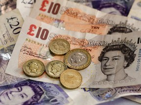 British 10 and 20 pound bank notes and one and two pound coins.