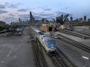 FILE - An Amtrak passenger train departs Chicago in the early evening headed south Wednesday, Sept. 14, 2022, in Chicago. President Joe Biden said Thursday, Sept. 15, 2022, that a tentative railway labor agreement has been reached, averting a potentially devastating strike before the pivotal midterm elections.