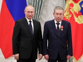 Russia's President Vladimir Putin, left, and Ravil Maganov, right, chairman of the board of directors of oil company Lukoil, pose for a photo during an awarding ceremony at the Kremlin in Moscow on Nov. 21, 2019.