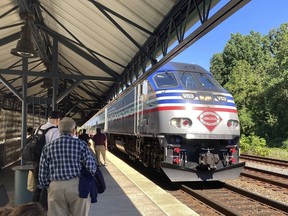 Commuters wait to board an arriving Virginia Railway Express commuter train Wednesday, Sept. 14, 2022 at the Crystal City station in Arlington, Va. September was shaping up as a good month for commuters on Virginia Railway Express outside the nation's capital, with the service offering free rides all month to lure back riders lost during the pandemic. Now, though, a freight rail strike threatens to shut down service on the VRE entirely, along with numerous other commuter rail services across the country.