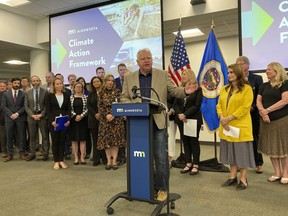 Minnesota Democratic Gov. Tim Walz on Friday, Sept. 16, 2022, rolls out a framework for fighting climate change that shows his proposed direction on the environment if he wins a second term, a sweeping plan that would slash carbon emissions and speed the switchover to electric vehicles. Walz announced the package at a research facility of the company Ecolab in the Minneapolis-St. Paul suburb of Eagan, Minn., one week before early voting starts in an election in which control of the governor's office and both houses of the divided Legislature are at stake.