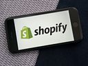 The Shopify Inc. logo  displayed on a smartphone.