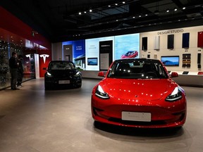 Tesla Model 3 cars are seen at a Tesla showroom in Beijing. Photographer: Jade Gao/AFP/Getty Images