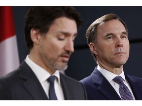 Bill Morneau, shown alongside Justin Trudeau in March 2020, resigned as finance minister amid a public disagreement with the prime minister.