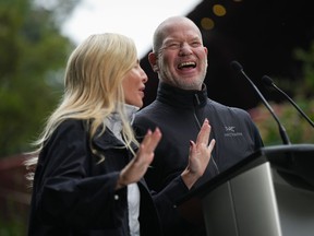 Lululemon founder Chip Wilson and his wife Summer Wilson laugh while speaking after announcing a $100 million donation to preserve and protect B.C.'s natural spaces through their Wilson 5 Foundation, in Vancouver, B.C., Thursday, Sept. 15, 2022.