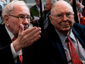 Warren Buffett, left, CEO of Berkshire Hathaway, has a word with his right-hand-man Charlie Munger at the annual shareholders meeting. The sage of Omaha says the time to buy is when other investors get fearful.