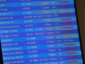 FILE - The arrivals board at the American Airlines terminal at LaGuardia Airport displays the flights that have been canceled or delayed and one that is on time, March 21, 2020, in New York. Flight delays and cancellations have bedeviled airline travel so far this year. The Transportation Department is launching a customer service dashboard to assist vacationers ahead of the travel-heavy Labor Day weekend.