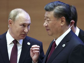 Russian President Vladimir Putin, left, gestures while speaking to Chinese President Xi Jinping during the Shanghai Cooperation Organization (SCO) summit in Samarkand, Uzbekistan, Friday, Sept. 16, 2022.
